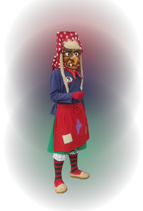 Person in traditioneller Tracht mit rot-weiß gepunktetem Kopftuch, blauem Oberteil, roter Schürze, gestreiften Strümpfen und Bastschuhen.